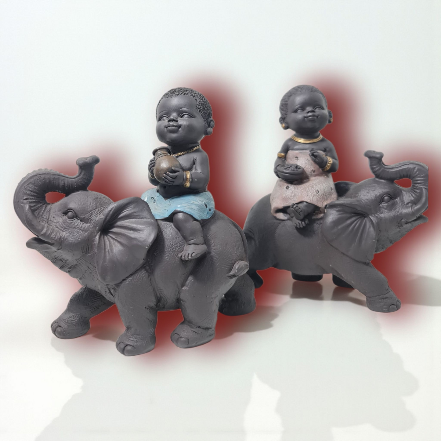 pareja de figuras sentadas sobre elefantes , decoracion del hogar