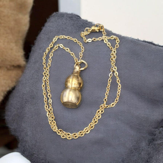 Amuleto collar calabaza con carga de proteccion, secretos del vodun, arte tradicional africano